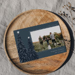 Silver Pine | Elegant Christmas Photo Foil Holiday Card<br><div class="desc">A modern and elegant Christmas holiday card design featuring a horizontal photo on a navy blue background adorned with pine trees trimmed with silver foil and topped with stars. Personalise with your custom holiday greeting,  family name and the year.</div>