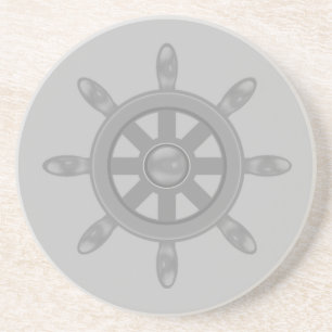 Silver ship wheel on light grey coaster