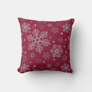 Silver snowflakes on dark red cushion