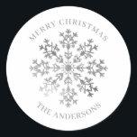 Silver Winter Snowflake Christmas Classic Round Sticker<br><div class="desc">Add a festive touch to your holiday gifts, cards, and party favours with this elegant silver snowflake Christmas sticker. Featuring a sparkling snowflake design with "Merry Christmas" and space to personalise with your family name, these custom stickers are perfect for sealing envelopes, decorating packages, or adding a thoughtful finishing touch...</div>