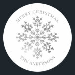 Silver Winter Snowflake Christmas Classic Round Sticker<br><div class="desc">Add a festive touch to your holiday gifts, cards, and party favours with this elegant silver snowflake Christmas sticker. Featuring a sparkling snowflake design with "Merry Christmas" and space to personalise with your family name, these custom stickers are perfect for sealing envelopes, decorating packages, or adding a thoughtful finishing touch...</div>