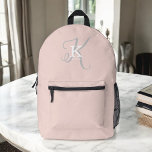Simple Blush Pink with Stylish Monogram Typography Printed Backpack<br><div class="desc">A cute feminine backpack design with a stylish layout of your name and monogram with classic serifs and a more ornate script typography in a balanced symmetry. The three elements blend together with a sophisticated harmony and create your own personal branding logo. Shown here with a blush pink background with...</div>