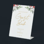Simple Classic Christmas Wedding Guest Book Sign<br><div class="desc">This simple classic Christmas wedding guest book sign features a clean, bright white backdrop with simple, minimalist black and gold lettering and handwritten calligraphy accents. Embellishments of beautiful and classic green and red Christmas wreaths with delicate gold features create a perfect winter holiday aesthetic while maintaining a polished elegance for...</div>