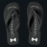 Simple Fun Groomsman Name & Bow Tie Wedding Thongs<br><div class="desc">These fun flip flops are a great way to thank the groomsmen at your wedding, and a wonderful way to give his feet a break after a long day! They feature a simple white on black design with his name at the top, the word "Groomsman" spelled out in classy letters...</div>