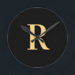 Simple Monogram Modern Black Gold Round Clock<br><div class="desc">This is a simple, modern, personalised monogram design. This stylish design is in trending black and gold with stylish typography. It's perfect for a personalised gift or ideal as a stylish new home decor accessory for yourself. Simply add your initial letter by typing it into the personalise this text box....</div>