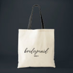 Simple Stylish Script Bridesmaid Personalised Name Tote Bag<br><div class="desc">Elevate your bridal party aesthetic with this simple stylish script bridesmaid personalised name design, perfect for a chic and modern celebration. Featuring minimalist, elegant black typography, this trendy script seamlessly elevates any tote bag or wedding accessory. It is the perfect way to present a beautifully coordinated name bridesmaid wedding favour...</div>