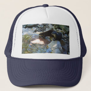 **"Sips by the Stream: Otters Drinking from River Trucker Hat