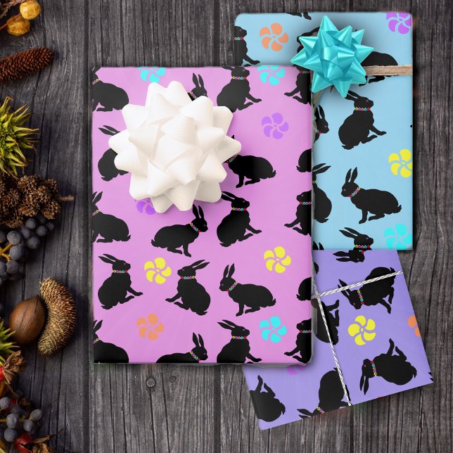 Sitting Black Bunnies Wearing Flowers on Pastels Wrapping Paper Sheet (Black rabbits with flowers on pastel gift wrap sheets for birthday or Easter in pink, purple, blue.)