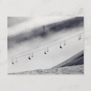Skiers on a chair lift postcard