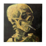 Skull with Burning Cigarette by Vincent van Gogh Ceramic Tile<br><div class="desc">Skull with Burning Cigarette by Vincent van Gogh is a vintage fine art post impressionism still life painting. A portrait of human skeleton smoking. Great image to use for anti-smoking products. Smoking kills 1, 000s every year, help someone to quit smoking today. Great image for Halloween or Día de los...</div>
