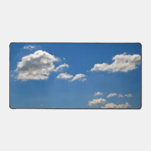 Sky is blue and white clouds are passing by  desk mat