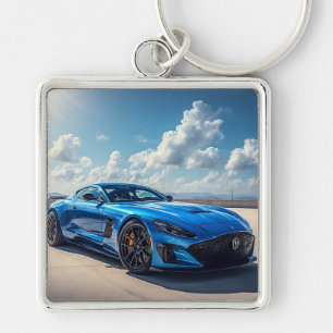 Sleek Blue Sports Car Under a Vibrant Cloudy Sky Key Ring