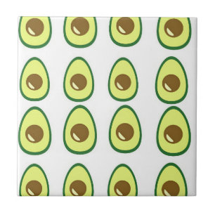 Sliced green avocado on white ceramic tile