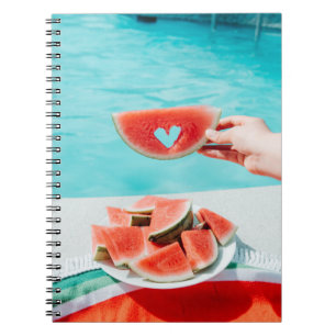 Sliced watermelon on white paper notebook