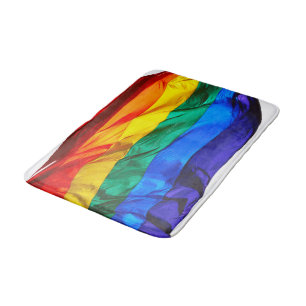 SlipperyJoe's gay pride flag waving pride colours  Bath Mat