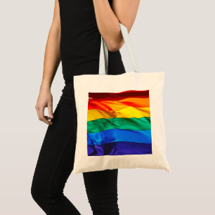 SlipperyJoe's gay pride flag waving red orange yel Tote Bag