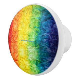 SlipperyJoe's tie-dyed flag rainbow pressed into s Ceramic Knob