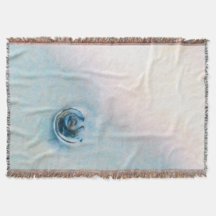 Slow motion wave toward a blue seashell throw blanket