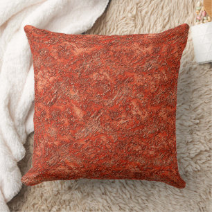 Small furrow texture on cardinal red to copper cushion
