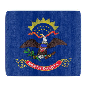 Small glass cutting board with North Dakota flag