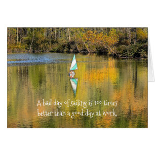 SMALL SAILBOAT ON LAKE WITH FALL REFLECTIONS