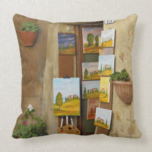 Small shope with artwork for sale on sidewalk cushion