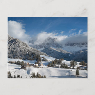 Small village with Dolomites mountains in the snow Postcard