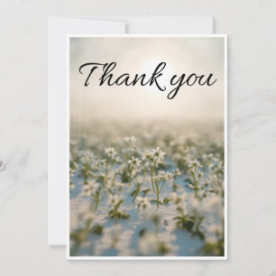 small white flower scattered across thank you card