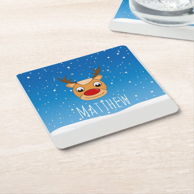 Smiling reindeer snowfall personalised blue square paper coaster (Angled)