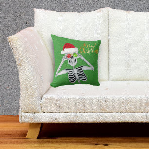 Smiling Skeleton Holding Ornaments to Eyes Green Cushion