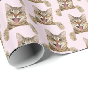 smiling tabby cat on pink wrapping paper