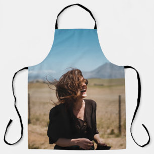 Smiling woman on brown and green field apron