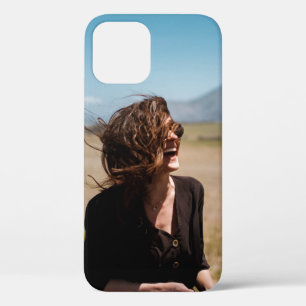 Smiling woman on brown and green field iPhone 12 case