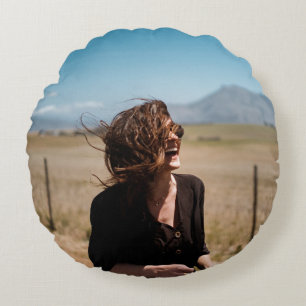 Smiling woman on brown and green field round cushion