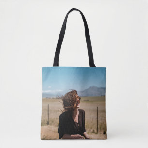 Smiling woman on brown and green field tote bag
