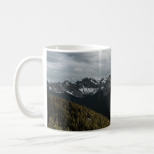 SNOW-CAPPED GRAY ROCKY MOUNTAIN UNDER CLOUDY SKY D COFFEE MUG (Left)
