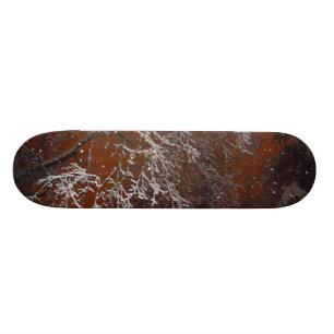 Snow Covered Tree Branches Against Red Storm Sky Skateboard