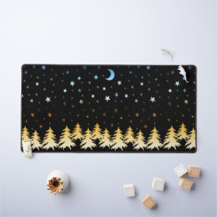 Snow-covered trees in the glow of gold blue stars desk mat