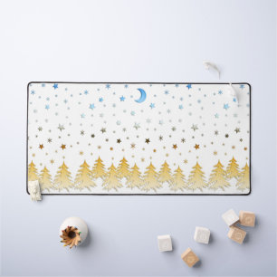 Snow-covered trees in the glow of gold blue stars desk mat