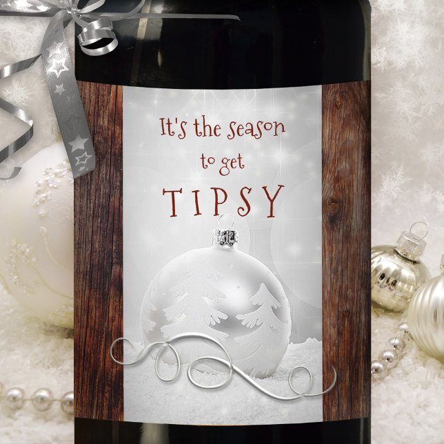 Snow Silver Dark Wood Christmas Wine Label (Funny wine label showing a silver Christmas bauble and silver swirl in snow on rustic dark wood )