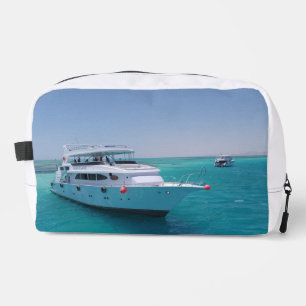 Snow-white yacht near the White Island in Red Sea Dopp Kit
