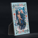 Snow Winter Floral Christmas Photo Plaque<br><div class="desc">Tabletop built-in photo easel features your favourite photo surrounded by snow and winter flowers - poinsettias, berries and leaves - on ANY COLOR BACKGROUND (we show blue.) Change the YEAR (in the lower right corner) or it can be deleted. Great as a gift or to display your favourite photo in...</div>