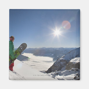 Snowboarder looking from mountain top magnet