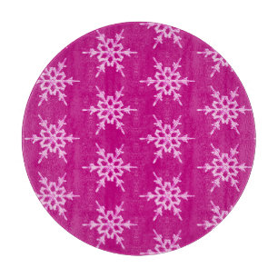 Snowflakes, pale pink crystals on magenta cutting board