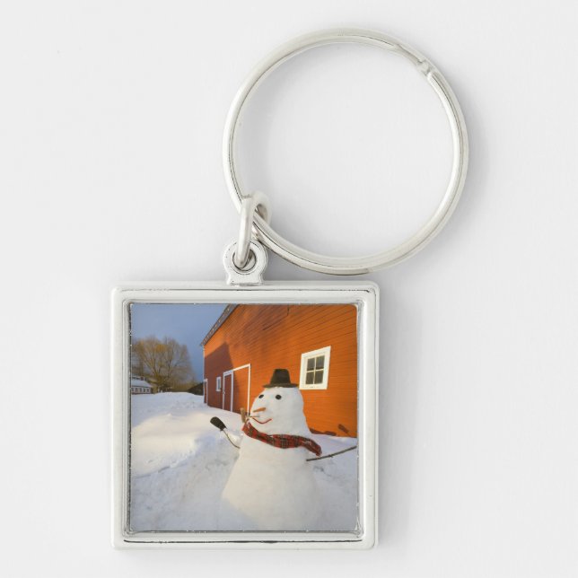 Snowman in front of red barn in Columbia Falls Key Ring (Front)