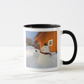 Snowman in front of red barn in Columbia Falls Mug