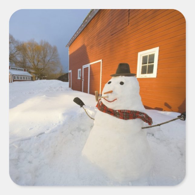 Snowman in front of red barn in Columbia Falls Square Sticker (Front)