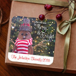 Snowman Merry and Bright Rustic Custom Name Cute Square Sticker<br><div class="desc">A close-up photo of a happy and cute, rustic log snowman, wrapped in a red and white striped scarf against lighted trees helps you usher in Christmas and New Year. Feel the warmth and joy of the holiday season whenever you use this fun and unique custom sticker. Matching cards, envelopes,...</div>