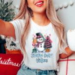 Snowman Vibes Women's T-Shirt<br><div class="desc">Snow day t-shirt, cute winter shirt, festive snowman tee, women’s holiday wear, cosy winter vibes shirt. Get into the winter spirit with this cheerful "Snow Day Vibes" tee! Featuring a cute snowman with a pink scarf and a festive tree, it's the perfect shirt for those cosy, snowy days. 𝐓𝐡𝐞 ☛​̳"​̳𝙀​̳𝘿​̳𝙄​̳𝙏​̳...</div>