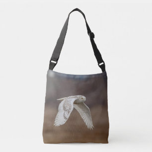 Snowy owl in flight crossbody bag